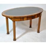 A late 19th century oval walnut side table with leather top above drawer and fluted legs.
