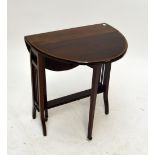 An Edwardian mahogany Sutherland table, the crossbanded oval top above stretchered supports,