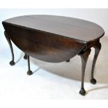 An Edwardian red walnut drop leaf table,