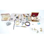 A quantity of costume jewellery including a large selection of brooches,