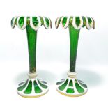 A pair of late 19th century Bohemian white and carved green glass tapering vases,