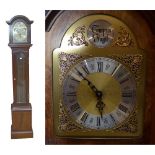 A reproduction mahogany longcase clock with glazed door and twin brass weights.