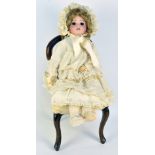 An early 20th century French SFBJ doll, the bisque porcelain head with open/close brown glass eyes,