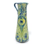MOORCROFT; a Florian Ware floral tubeline decorated ewer of tapering form,