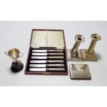 A small collection of hallmarked silver items comprising a small twin handled trophy cup on a stand,