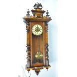 A late Victorian walnut/beech eight day spring drive Vienna wall clock with eagle finial,