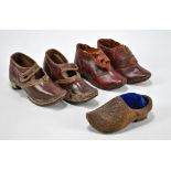 Two pairs of children's clogs, one pair with ankle straps, shaped toes and slight heels,