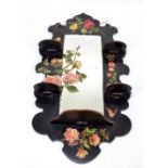 A late Victorian papier mâché floral decorated mirror with four shelves above a larger shelf,