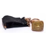 A 9ct rose gold pierced fob set with a large citrine stone suspended on a grosgrain ribbon with 9ct