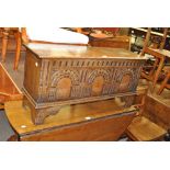 A light oak coffer of small proportions with carved repeated detail to front,