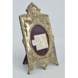 An Elizabeth II hallmarked silver rectangular photograph frame with ornamental scallop top,