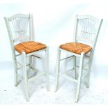 A pair of contemporary cream painted bar stools with rush seats.
