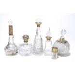 Six variously hallmarked silver mounted clear cut glass scent bottles to include a globular example