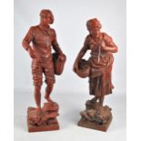 A pair of 19th century red spelter figures of a man and a woman gathering fish and shrimp,