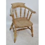 An early 20th century smoker's bow back chair with turned spindle splats on turned baluster