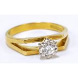 An 18ct yellow gold solitaire ring, the raised platform set with a single brilliant cut diamond,