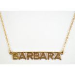 A 9ct yellow gold necklace with pendant inscribed 'Barbara', approx 2.1g.