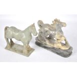 A carved onyx model of a horse on a shaped stand and unusual pottery model of a standing horse with