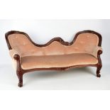 A doll sized mahogany framed double chair back upholstered sofa raised on cabriole legs to whorl