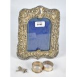 SYDNEY & CO; an Edward VII hallmarked silver photo frame embossed with foliate scrolls,