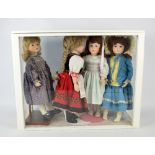 A group of bisque porcelain headed dolls with glass eyes and painted features with ceramic arms and