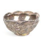 A late 19th/early 20th century Chinese Export white metal bowl with shaped rim and embossed floral