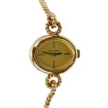 ROY KING; a lady's vintage 9ct yellow gold wristwatch with oval dial and rope twist bracelet,