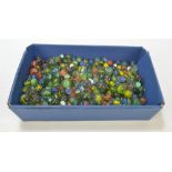 A collection of marbles of varied size and colour.