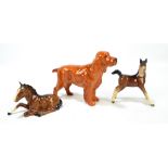 A Beswick 'Horse Shoe Primula' spaniel, a sitting foal in brown no.