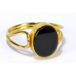 A 9ct yellow gold lady's signet ring set with oval vacant black onyx cartouche flanked by wire