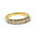 An 18ct yellow gold dress ring, set with seven round cut diamonds, size L, approx 3.2g.