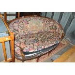 A late 19th century upholstered canapé with stained beech frame, woolwork upholstered back and seat,