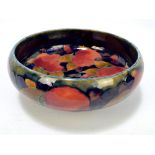 MOORCROFT; a 'Pomegranate' pattern tubeline decorated circular footed bowl,