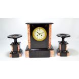 An early 20th century French black slate and rouge marble three piece clock garniture,