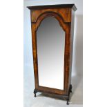 A late 19th century walnut mirror door wardrobe with single internal shelf above hanging space with