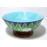 A large Victorian Majolica circular footed bowl decorated with water lily and various foliate