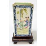 A circa 1900 Chinese rectangular sectioned vase with blue and white painted border and four main