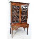 An Edwardian mahogany bookcase with pair of glazed hinged doors,