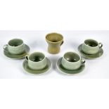 HUGO; a set of four green glazed stoneware cups and saucers, all with impressed marks to base,