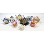 A group of nine ceramic teapots of varied size and form to include a circular Sadler example in the