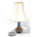 MOORCROFT; a pale blue ground 'Columbine' pattern tube line decorated lamp base,