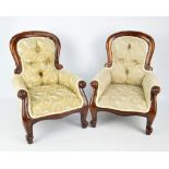 A pair of mahogany framed spoon back upholstered armchairs with carved foliate decoration on