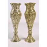 A pair of circa 1900 Persian white metal vases of slender inverted baluster forms,