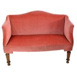 A Victorian mahogany framed upholstered enclosed settee with shaped back on turned tapering front