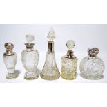 Five variously hallmarked silver mounted clear cut glass scent bottles to include two footed