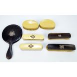 An ebony three piece dressing table set with applied hallmarked silver decoration,