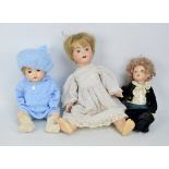 A group of bisque porcelain headed dolls with glass eyes and painted features,