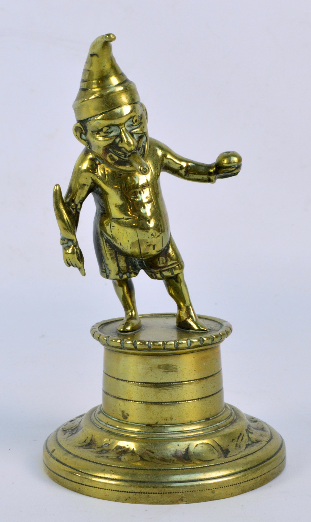 An early 20th century brass novelty lighter modelled as Mr Punch with cigar on a plinth, height 18.