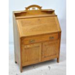 A late 19th/early 20th century Arts and Crafts oak bureau,