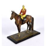 An Austrian cold painted spelter table lighter/spill holder in the form of a racing horse with a